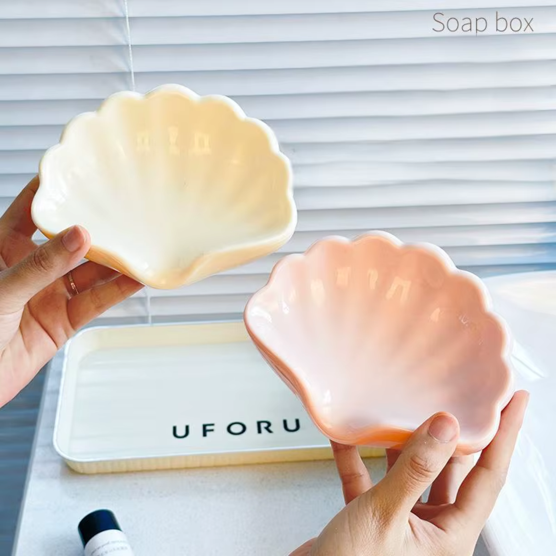 Best1 shell-shaped soap dish with drainage, elegantly designed for bathroom vanity use.